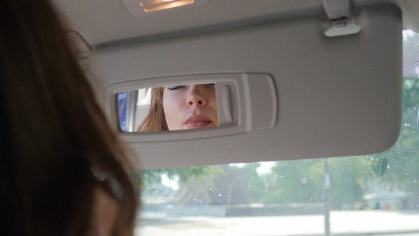 Feminine Lips and Eyes Reflected in Automobile Mirror, Stock Footage