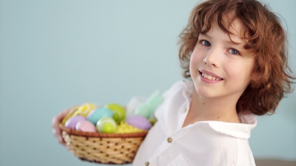 Cute Little Boy with an Easter Basket Smiling Looking at the Camera alt