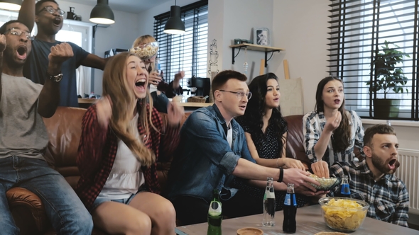 African American Friends Watching Sports on TV.  . Multi Ethnic Friends Celebrate Winning Togethe