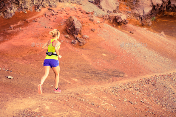 Young woman running in mountains summer sunset - Stock Photo - Images