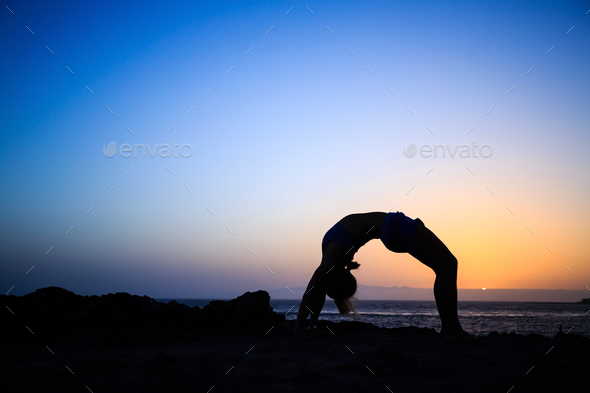Woman stretches yoga sunset silhouette - Stock Photo - Images
