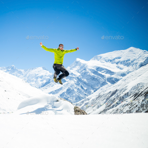 Happy man jumping success in mountains - Stock Photo - Images