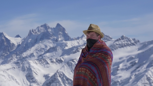 Man in National Clothes Against the Background of Mountains
