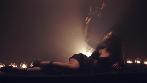 Sensual Woman on the Bed with Rose