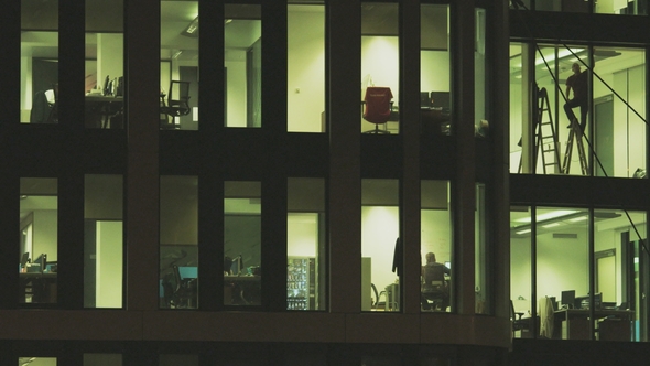 Man on the Ladder in Tall Office Building alt