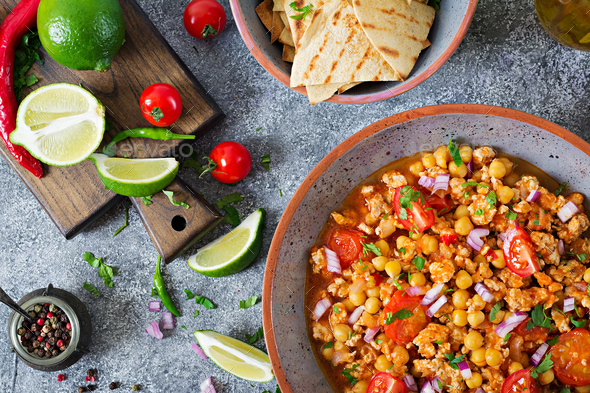 Chili con carne of turkey with chickpeas served with nachos. - Stock Photo - Images