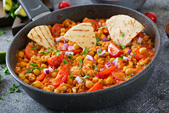 Chili con carne of turkey with chickpeas served with nachos. - Stock Photo - Images