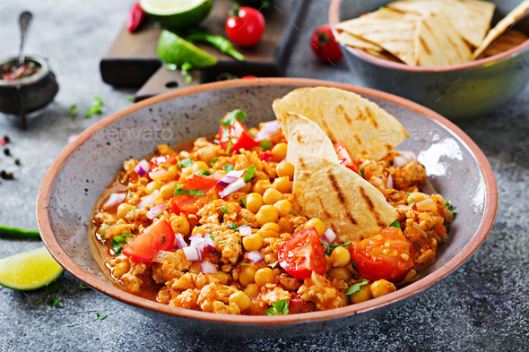 Chili con carne of turkey with chickpeas served with nachos. - Stock Photo - Images