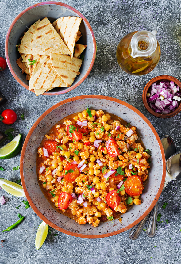 Chili con carne of turkey with chickpeas served with nachos. - Stock Photo - Images