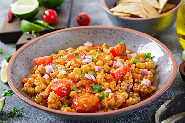 Chili con carne of turkey with chickpeas served with nachos - Stock Photo - Images