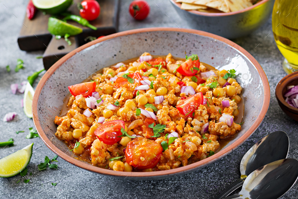 Chili con carne of turkey with chickpeas served with nachos. - Stock Photo - Images