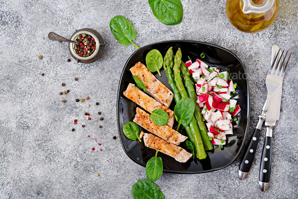 Chicken fillet cooked on a grill with a garnish of asparagus and radish salsa. - Stock Photo - Images