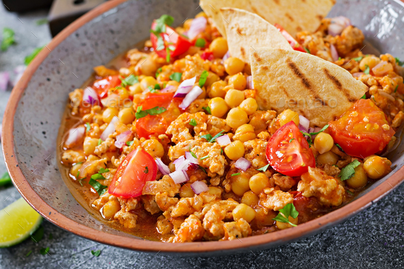 Chili con carne of turkey with chickpeas served with nachos. - Stock Photo - Images