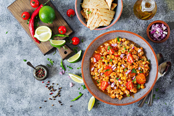 Chili con carne of turkey with chickpeas served with nachos - Stock Photo - Images