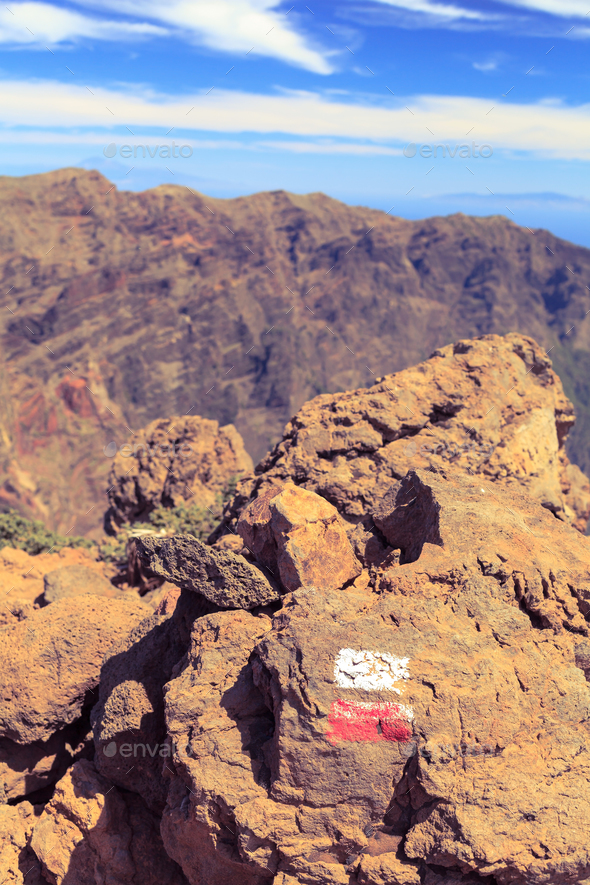 Trail sign on rock in beautiful mountains - Stock Photo - Images