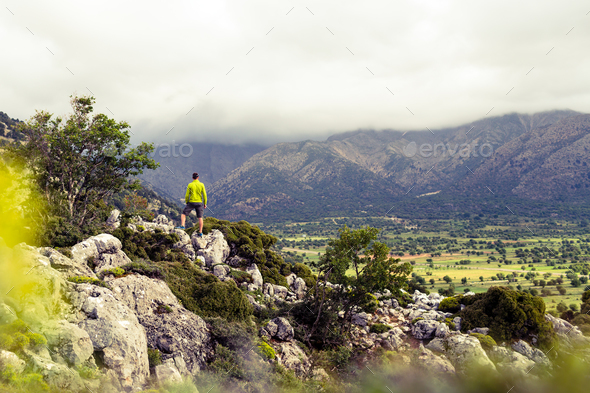 Hiking man looking at beautiful mountains - Stock Photo - Images