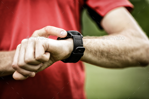 Runner looking at sport watch - Stock Photo - Images