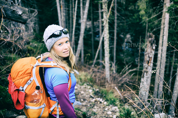 Woman hiking in winter cold dark winter forest - Stock Photo - Images