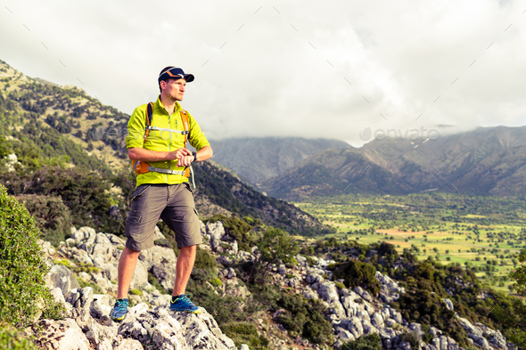 Hiking man checking direction in mountains - Stock Photo - Images
