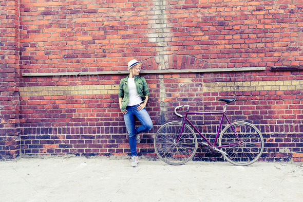 Young woman with vintage road bike in city - Stock Photo - Images