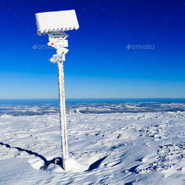 Sign and arrows in winter white mountains - Stock Photo - Images