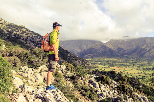 Hiking man looking at beautiful inspirational landscape - Stock Photo - Images