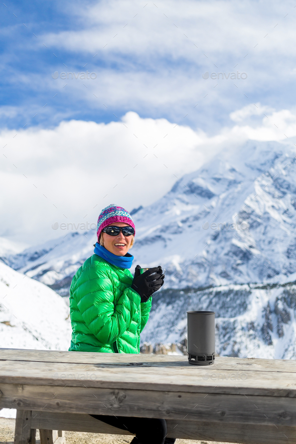 Woman drinking in winter mountain base camp - Stock Photo - Images