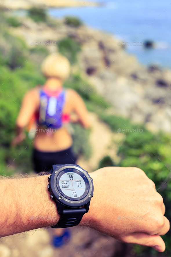 Runner looking at sport watch - Stock Photo - Images