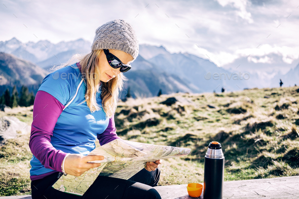 Woman checking map hiking in mountains - Stock Photo - Images