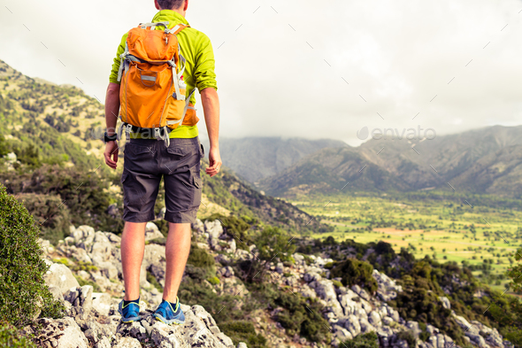 Hiking man looking at beautiful mountains - Stock Photo - Images