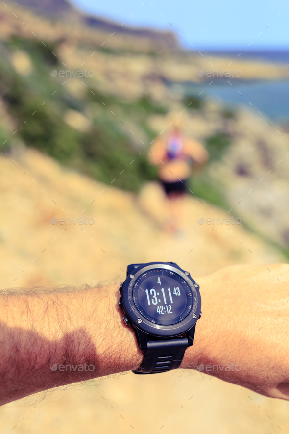 Runner looking at sport watch - Stock Photo - Images