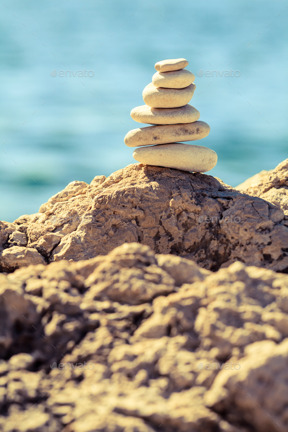 Stones balance at the beach, stack over blue sea - Stock Photo - Images