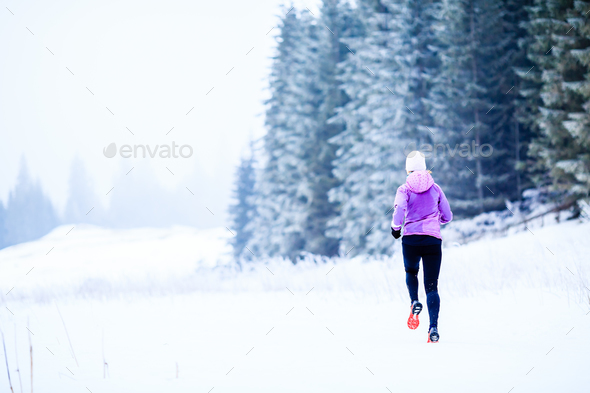 Woman running in winter, fitness inspiration and motivation - Stock Photo - Images