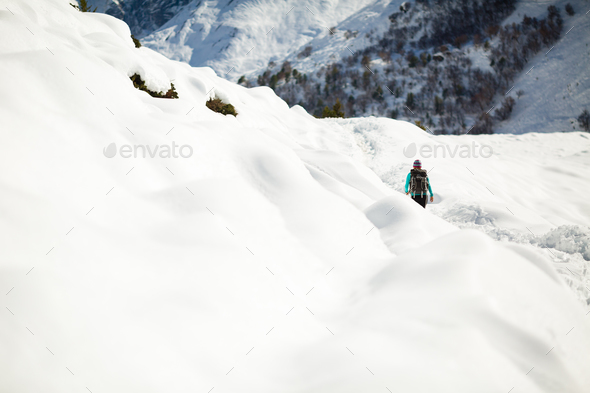 Woman hiking in white winter mountains - Stock Photo - Images
