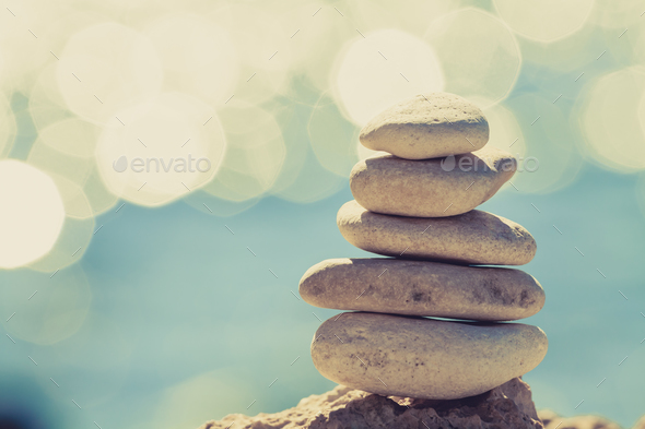 Stones balance at the beach, stack over blue sea - Stock Photo - Images