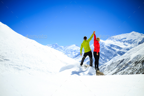 Couple hiking man and woman success in winter mountains - Stock Photo - Images