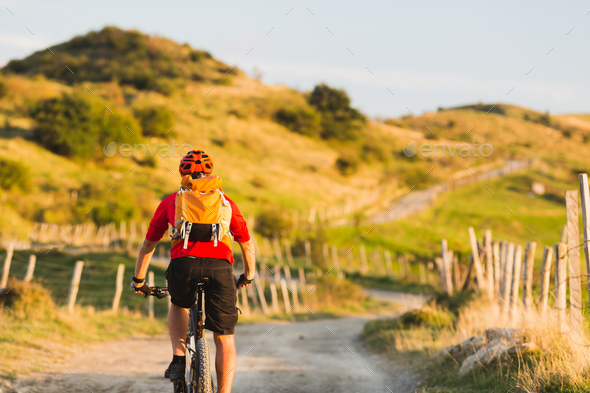 Bicycle riding enduro adventure in sunset mountains - Stock Photo - Images