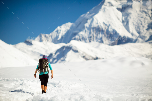 Woman walking in winter mountains - Stock Photo - Images