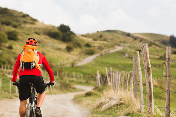 Biker cycling in beautiful mountains - Stock Photo - Images