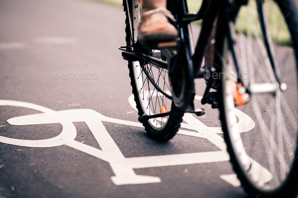 City bicycle riding on bike path - Stock Photo - Images