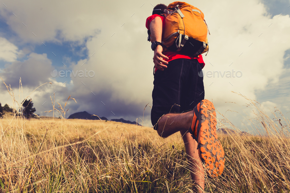 Hiker walking with backpack - Stock Photo - Images