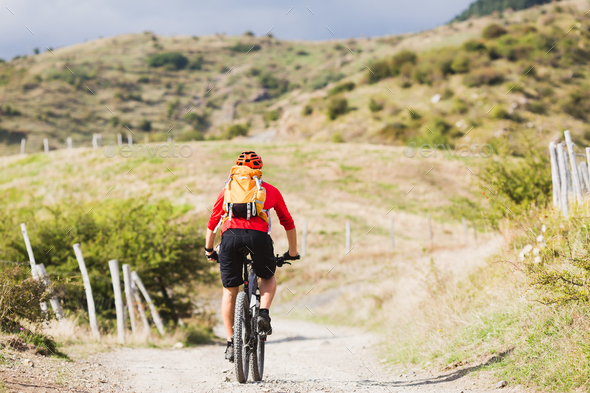 Man enduro mountain biking on country road - Stock Photo - Images