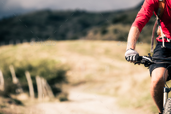 Mountain bike rider on country road, track trail in inspirationa - Stock Photo - Images