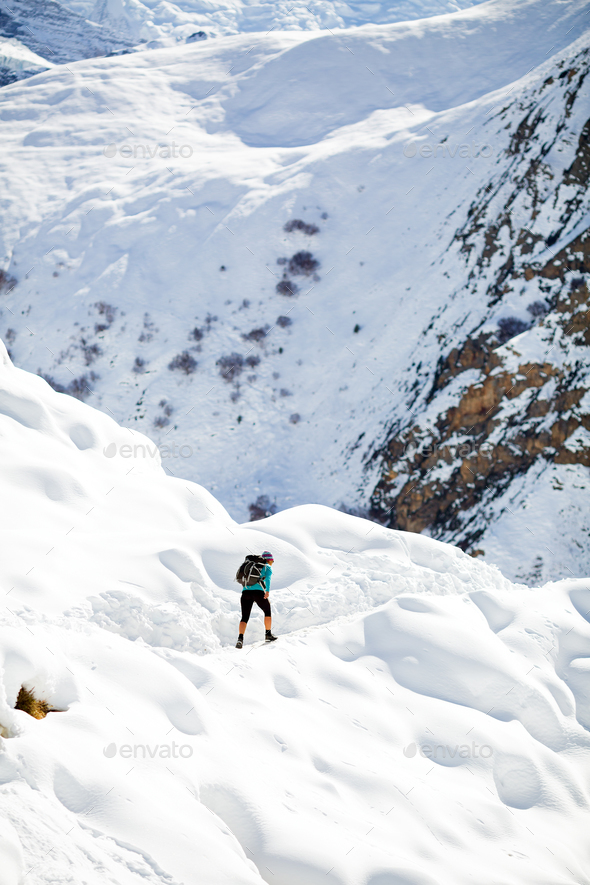 Woman hiking in white winter mountains - Stock Photo - Images