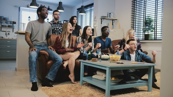 Multi-ethnic Fans Celebrate Success. Wide Shot. Crazy Football Sports Supporters Shout in Euphoria alt