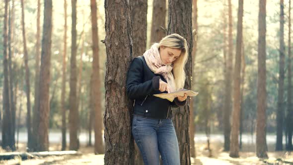 Traveler Explore Forest With Map. Wanderlust Travel Searching Right Direction. Girl Holding Map. alt