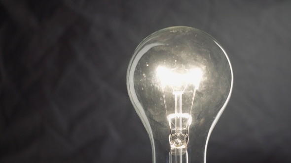 Light Bulb on Black Background. Idea Light Bulb alt