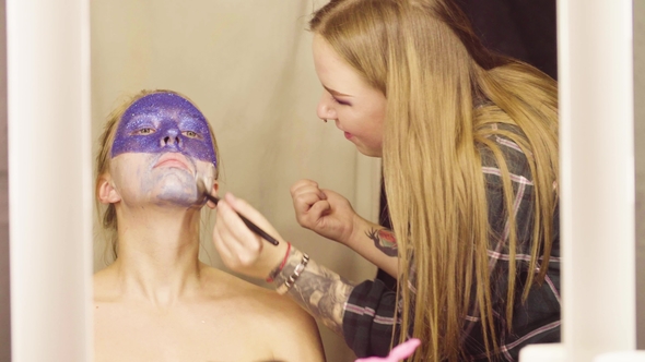 Face Art. The Make-up Artist Applying a Foundation
