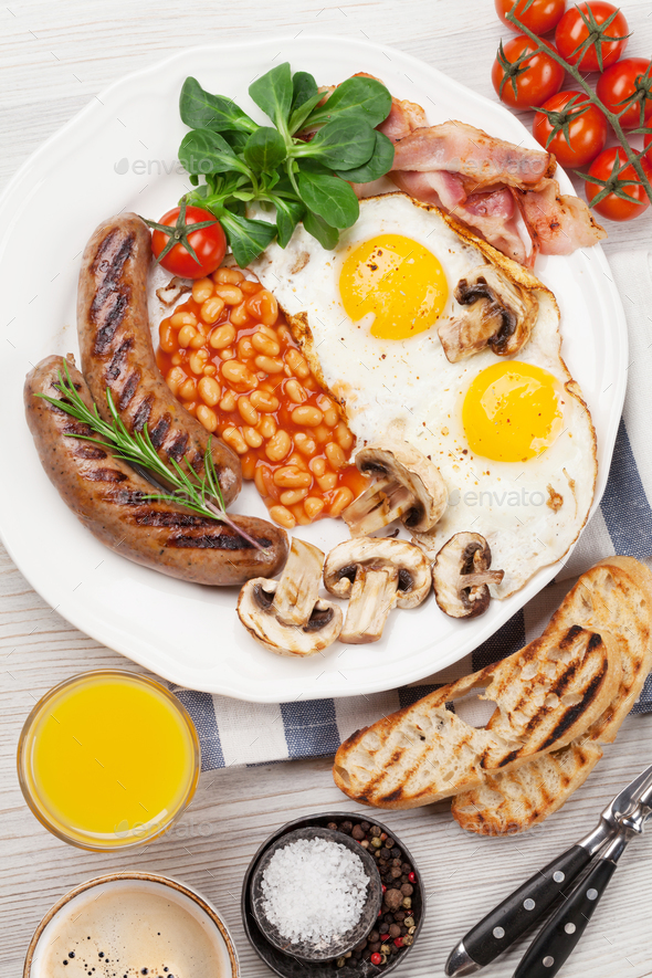English breakfast. Fried eggs, sausages, bacon - Stock Photo - Images