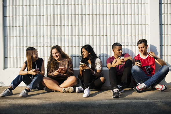 Group of young teenager friends chilling out together using smartphone social media concept Stock Photo by Rawpixel